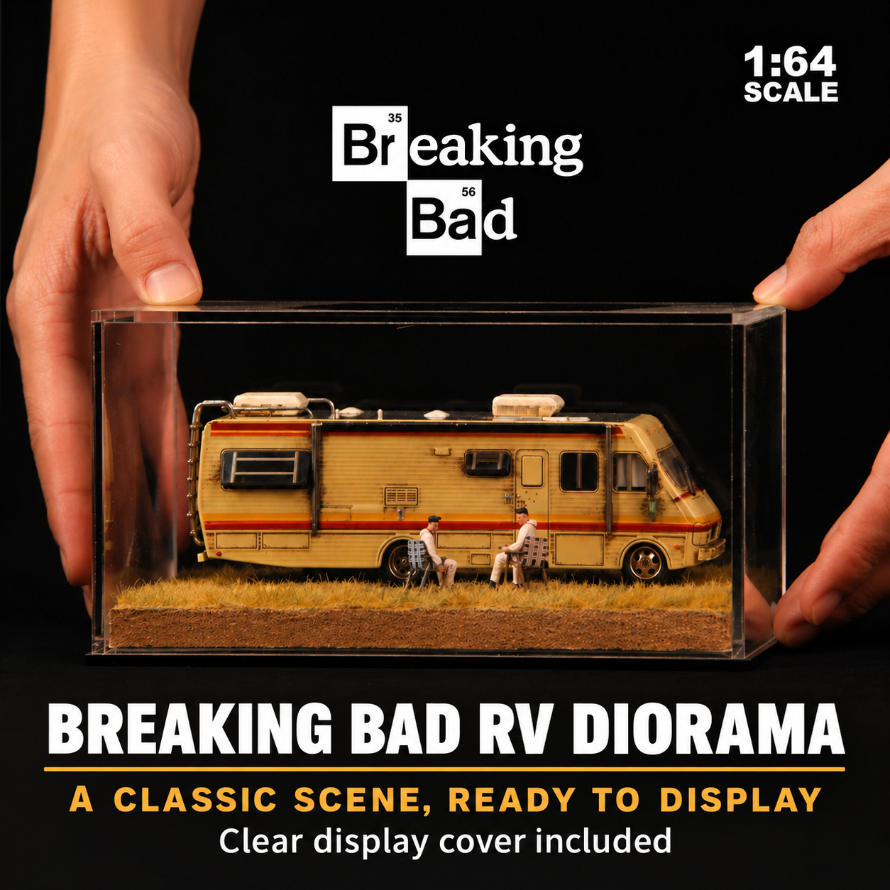 Hands beside the weathered RV diorama displayed under its clear cover